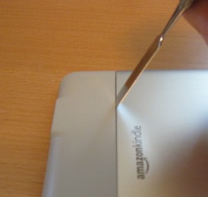 Using a spudger to separate the Kindle's back panels